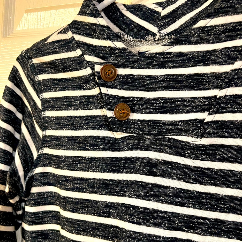Striped top with buttons .  Long sleeve sweater colored.  New without tag